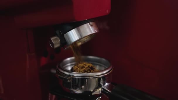 Coffee is poured into a cup from a coffee grinder - Filmati, video