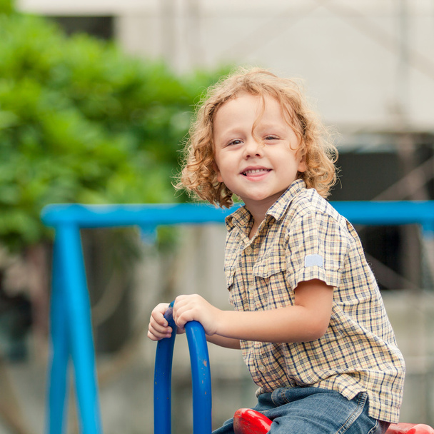 Happy little boy on the playground - Fotó, kép