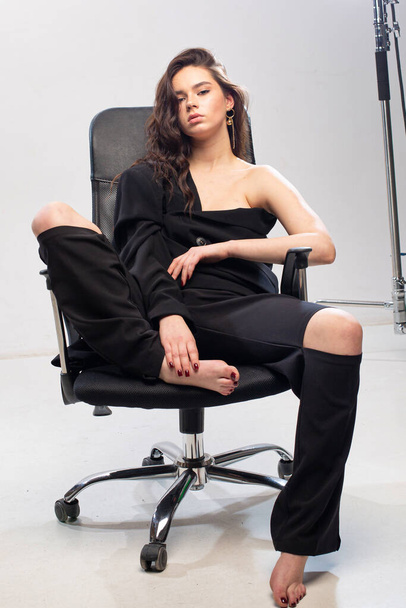 Dark hair young european girl with white skin in office chair - 写真・画像