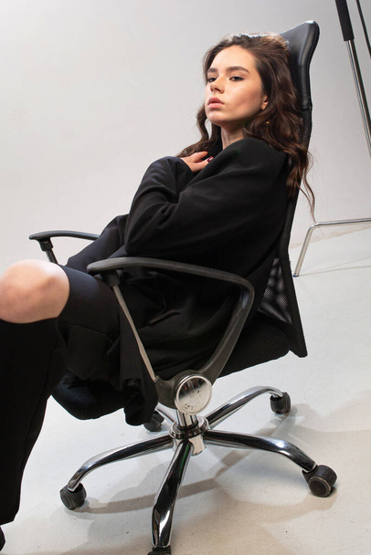 Young european girl with white skin in office chair - Photo, Image