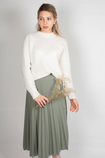 Romantic woman with long hair and white skin isolated on grey in white sweater and olive skirt - Fotoğraf, Görsel