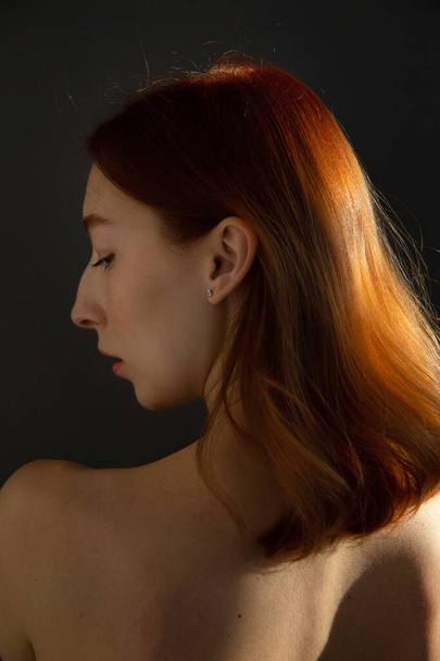 Red hair young european woman with white skin isolated on black - Valokuva, kuva