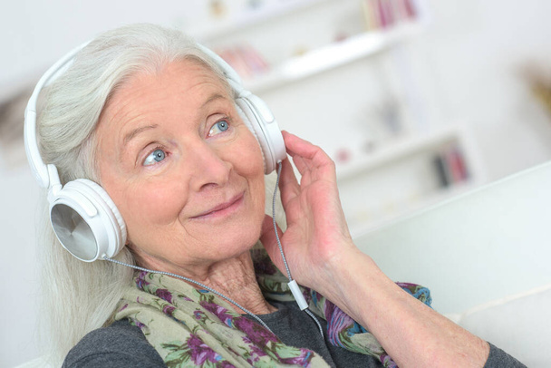 elderly woman wearing a headset - Foto, Bild
