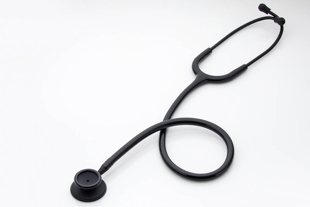 Stethoscope on a white background, top view - Φωτογραφία, εικόνα