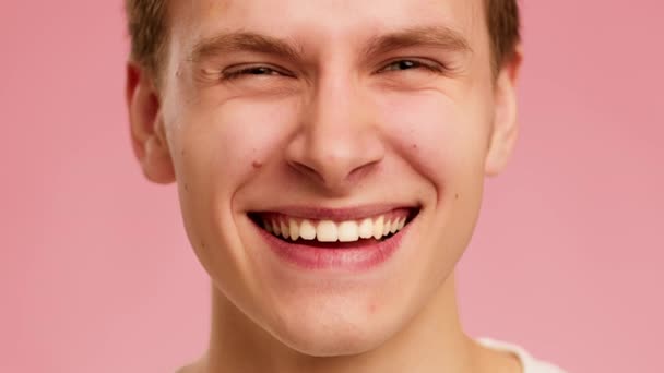 Cropped Shot Of Guy Smiling Looking At Camera, Pink Background - Video