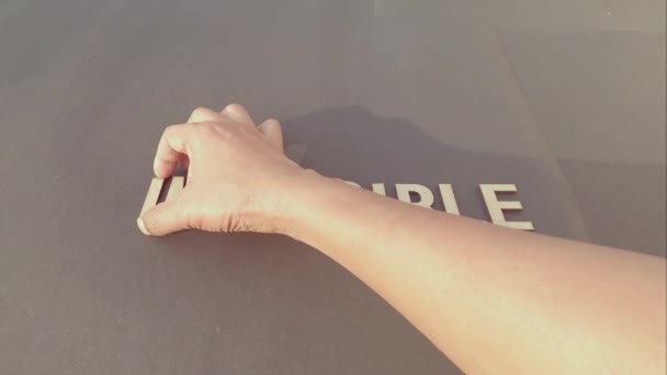 Impossible Means Im Possible If You Know How To Begin - Man hand separating I M letter from impossible an adding a smiley to say possible. Success and achievement determination concept. - Materiał filmowy, wideo
