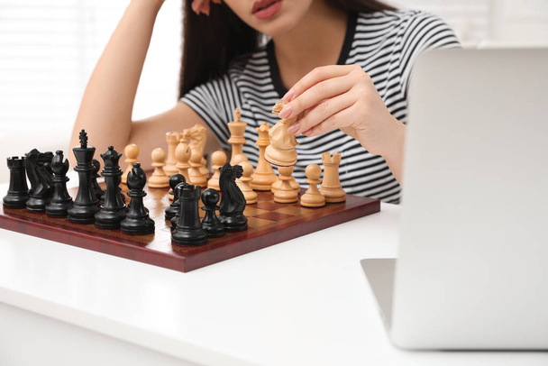 Woman playing chess with partner through online video chat at home, closeup - Fotoğraf, Görsel