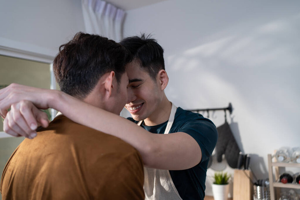 Asian attractive male LQBTQ hugging each other and starting foreplay. Handsome romantic man gay couple spending leisure time together making love in dark night room in house. Homosexual-LGBTQ concept. - Fotografie, Obrázek