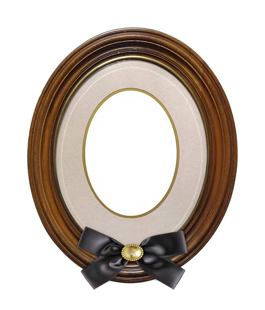 Wooden oval frame with black mourning ribbon for paintings, mirrors or photo isolated on white background - 写真・画像