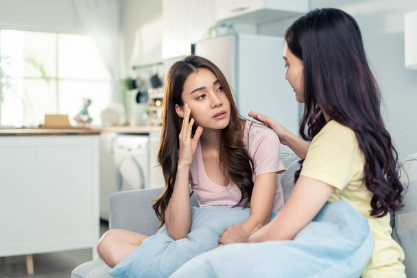 Asian beautiful woman comforts upset girl friend crying for problem. Attractive carring female support, consoling and understand empathy to stressed young sister in tears at home. Family relationship. - Photo, Image