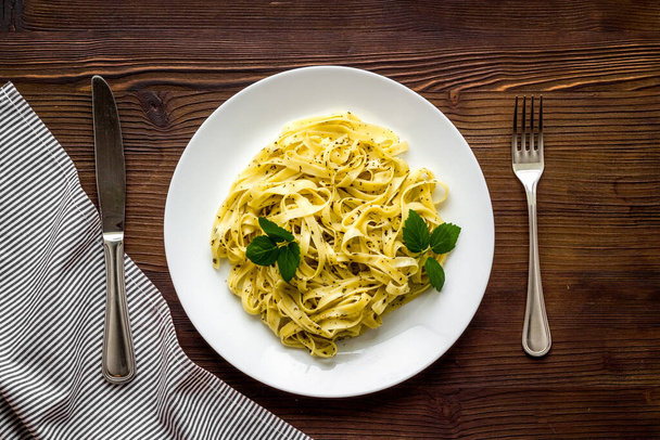 Italian pasta fettuccine with cream sauce and herbs - Foto, immagini