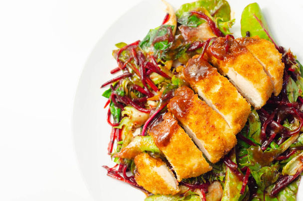 Breaded crispy chicken breast fillet with mixed salad and grated beetroot, tasty lunch - Foto, Imagem