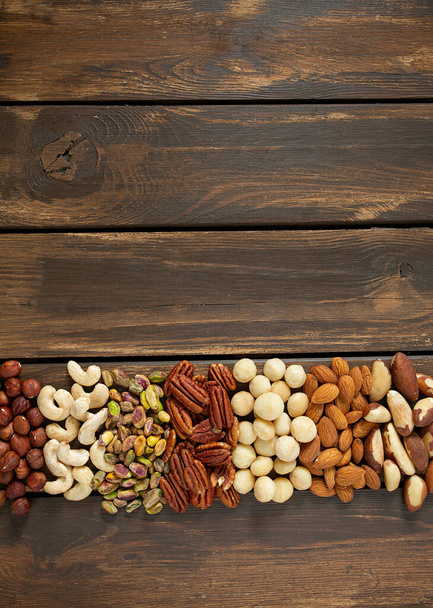 assortments of nuts on wooden surface - Φωτογραφία, εικόνα