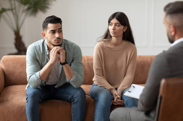 Couple talking at therapy session with professional male therapist - Foto, Imagem