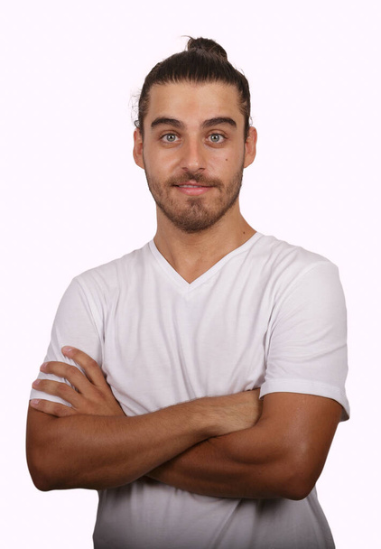 young man in white T-shirt with white background making funny gestures - Foto, Bild