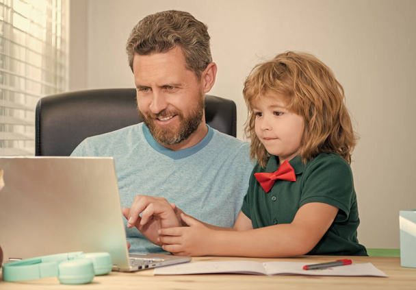padre felice e figlio bambino a scuola che lavora online su laptop, e-learning - Foto, immagini