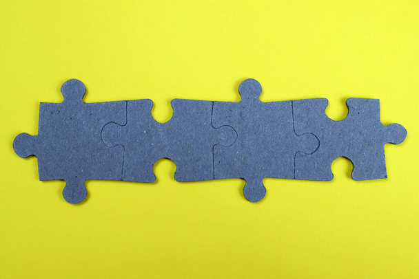 Puzzle pieces on a yellow background - Fotoğraf, Görsel