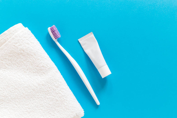 toothbrush, towel, flat lay, morning routine, text, oral care, teeth hygiene, caries, space for text, daily, blank, space, copy, colorful, blue, view, lay, top, flat, toiletries, cleaning, everyday, sanitation, hygienic, copy space, dentistry, health - Photo, Image