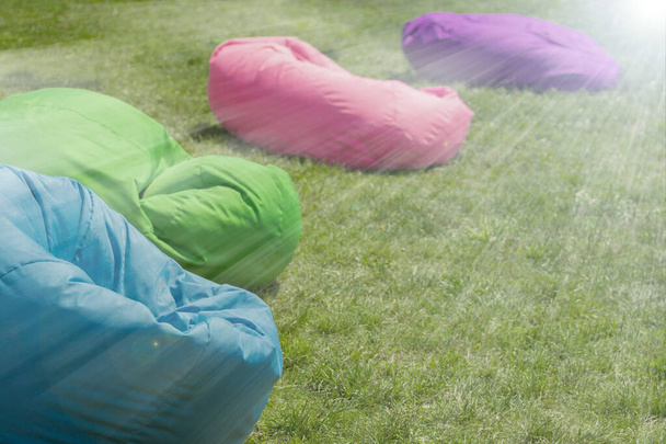 bean bag chairs.Bean bag chair on the lawn. Concept of comfortable  outdoor contemporary furniture. comfortable soft pillows for sitting and lying  - Photo, Image