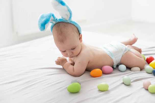 Boy dressed as bunny and Easter eggs - Fotografie, Obrázek