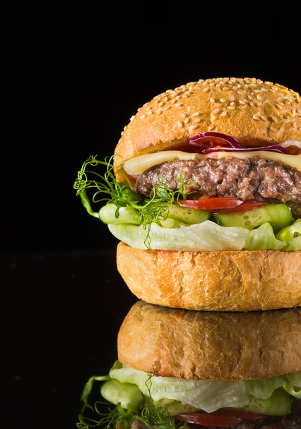 fresh burger with veal cutlet on a black background - Φωτογραφία, εικόνα