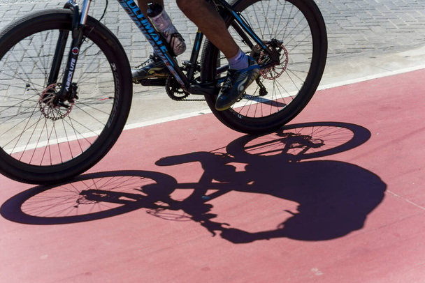 Salvador, Bahia, Brazil - August 15, 2021: Shadow of a bicycle on the bike path in the city of Salvador, Brazil. - Fotografie, Obrázek