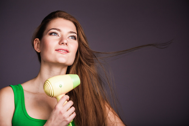 Woman with hair dryer - Foto, Bild