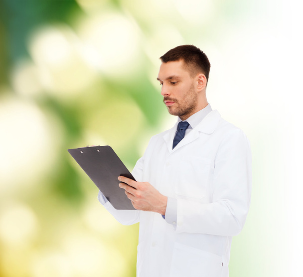 serious male doctor with clipboard - Foto, Imagen