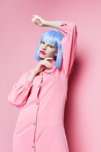 glamorous woman in blue wig pink dress red lips isolated background - Foto, Bild