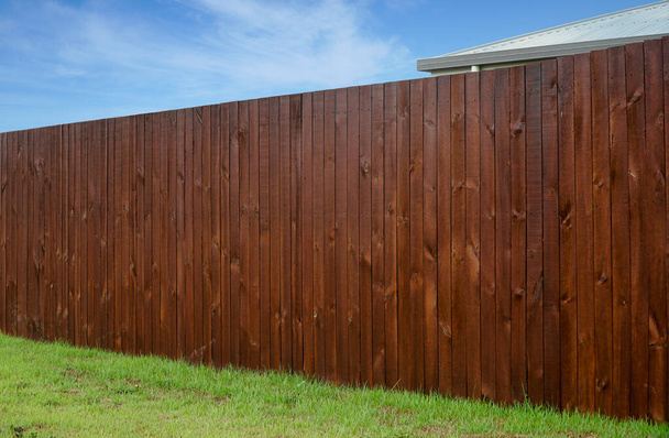 houten hek rond een huis voor home security gras op de voorgrond - Foto, afbeelding