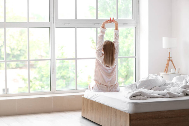 Morning of beautiful woman stretching on bed - Fotoğraf, Görsel