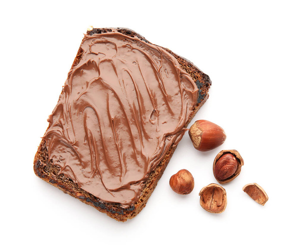 Bread with chocolate paste and hazelnuts on white background - Foto, immagini