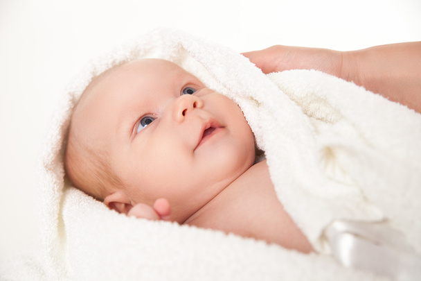 cute happy little baby hidden in white towels - Foto, imagen