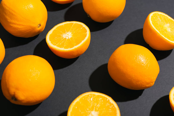 Fresh cut oranges on dark background, closeup - 写真・画像