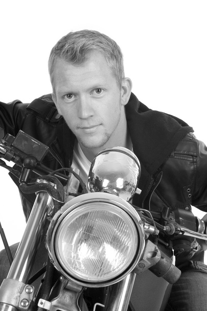 man on motorcycle black jacket lean forward facing close bw - Photo, Image