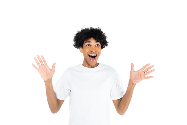 excited african american man with open mouth looking away and waving hands isolated on white - Foto, Imagen