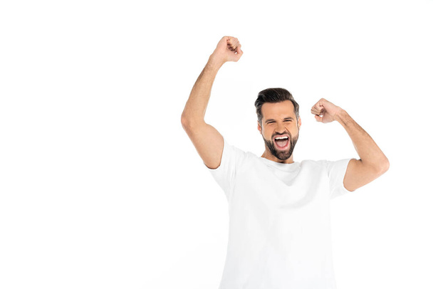 excited man screaming while showing triumph gesture isolated on white - Foto, imagen