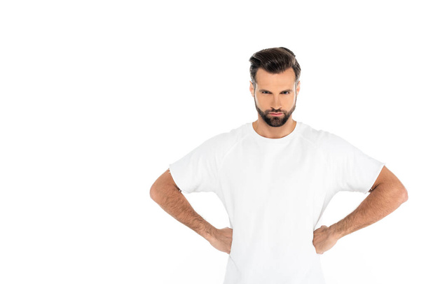 angry man looking at camera while standing akimbo isolated on white - Foto, Imagen