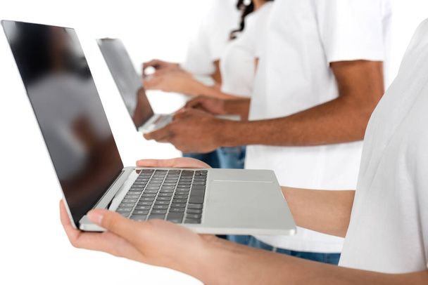 cropped view of blurred multicultural people with laptops isolated on white - Φωτογραφία, εικόνα
