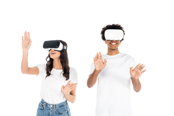 cheerful interracial friends gesturing while gaming in vr headsets isolated on white - Фото, зображення