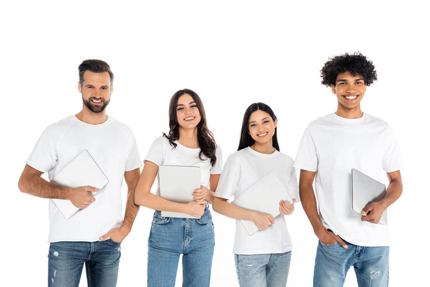 happy multiethnic men and women with laptops smiling at camera isolated on white - Photo, Image