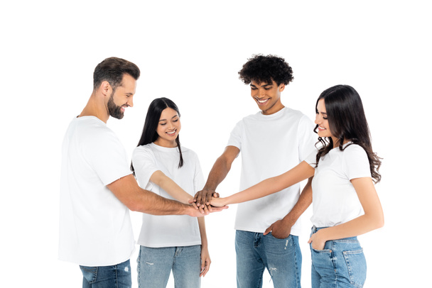 cheerful interracial friends in t-shirts joining hands isolated on white - Fotó, kép