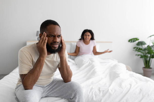 Unhappy young black wife freaks out and yells at her sad husband, man suffers from erectile dysfunction - Fotografie, Obrázek