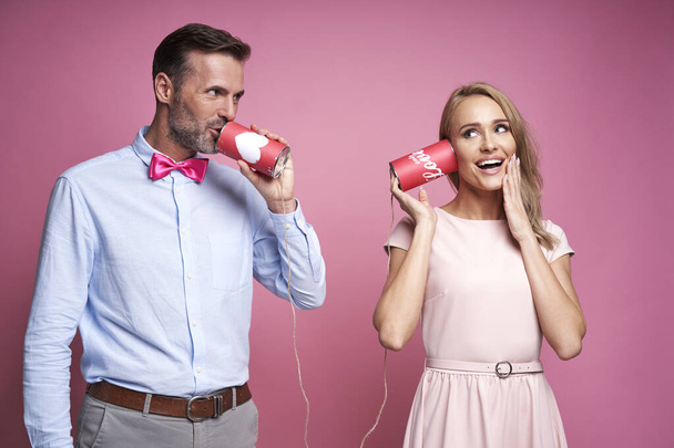 Caucasian couple pretending a phone call through cans - Fotografie, Obrázek