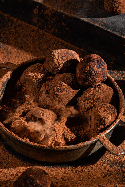 Dark chocolate truffle on dark background - Valokuva, kuva