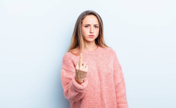 pretty caucasian woman feeling angry, annoyed, rebellious and aggressive, flipping the middle finger, fighting back - Photo, image