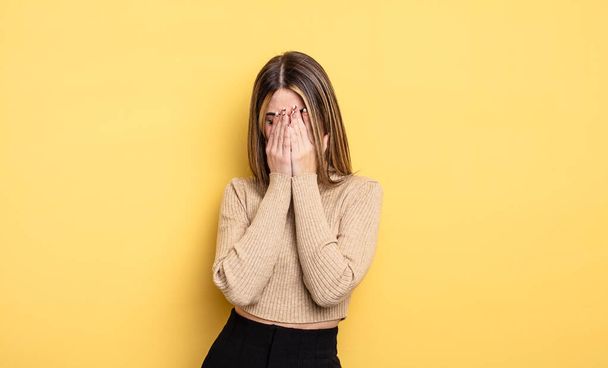 pretty caucasian woman feeling sad, frustrated, nervous and depressed, covering face with both hands, crying - Fotoğraf, Görsel