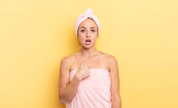 pretty woman looking shocked and surprised with mouth wide open, pointing to self. shower and beauty concept - 写真・画像