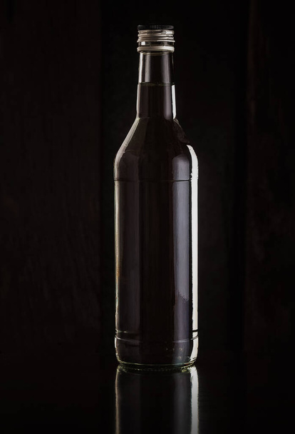 A bottle of vodka on a dark background - 写真・画像