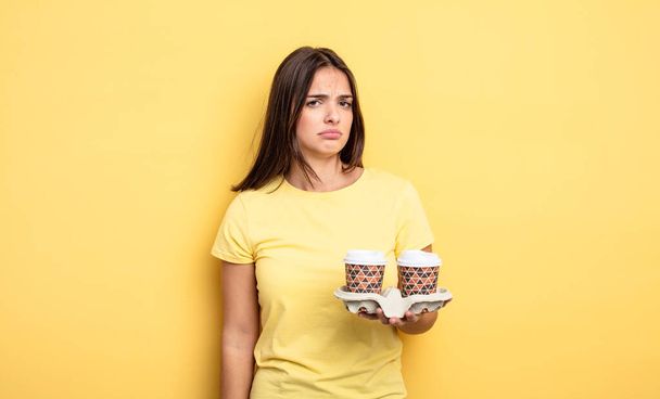 pretty woman feeling sad, upset or angry and looking to the side. take away coffee concept - Photo, image